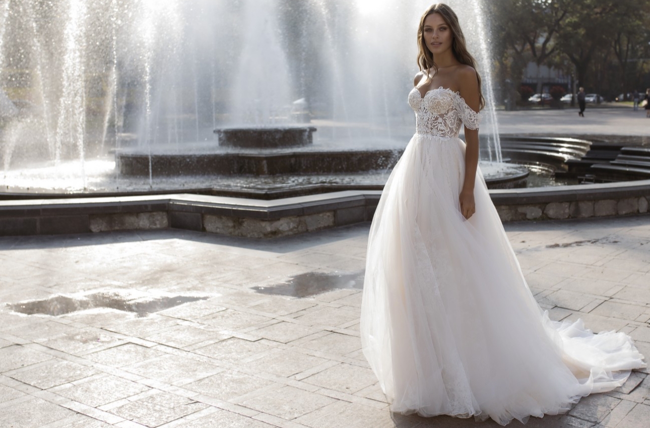 Bride poses in front of large fountain