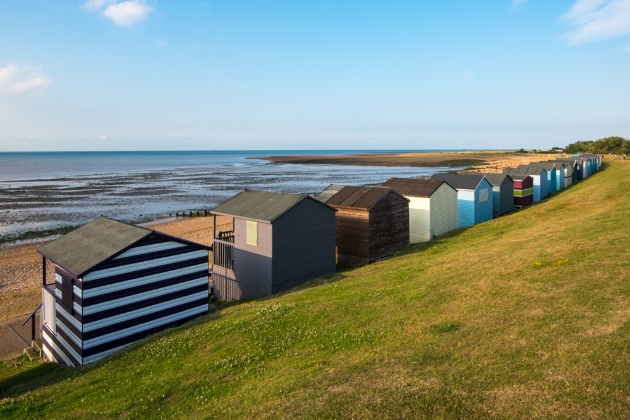 beach huts on edge of sand facing sea kent
