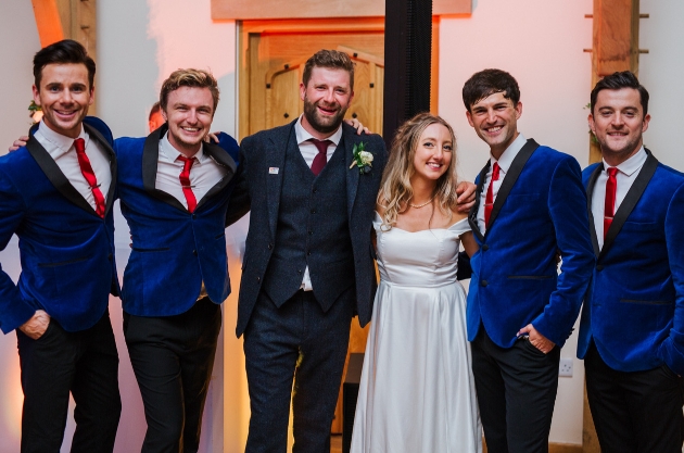 four band members with bride and groom