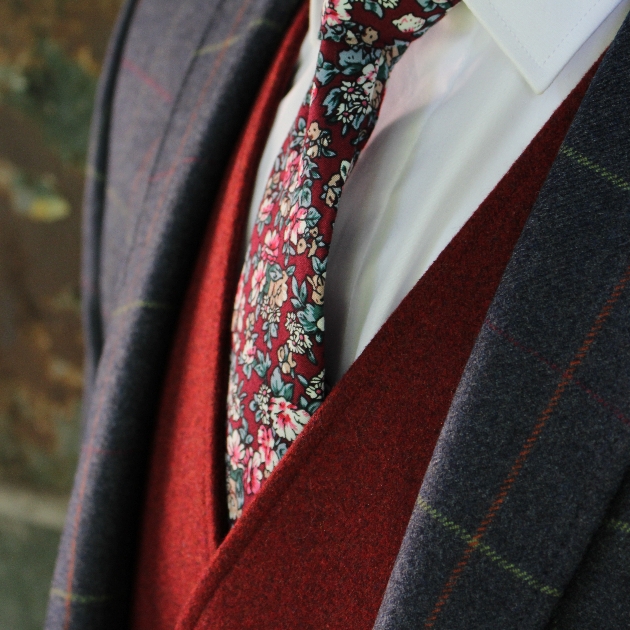 textured windowpane checked jacket worn with a rich-red contrasting waistcoat