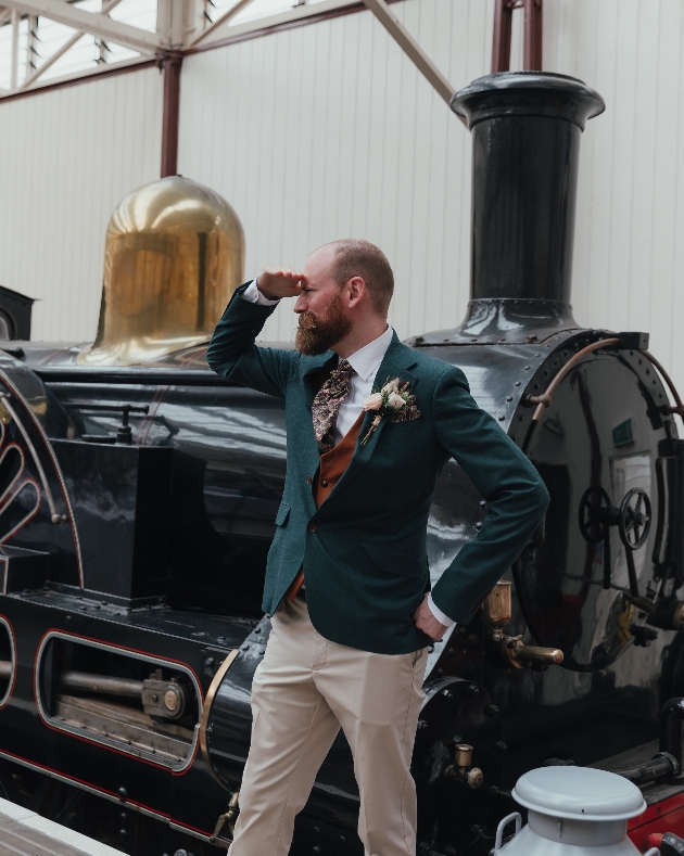 Groom poses with train