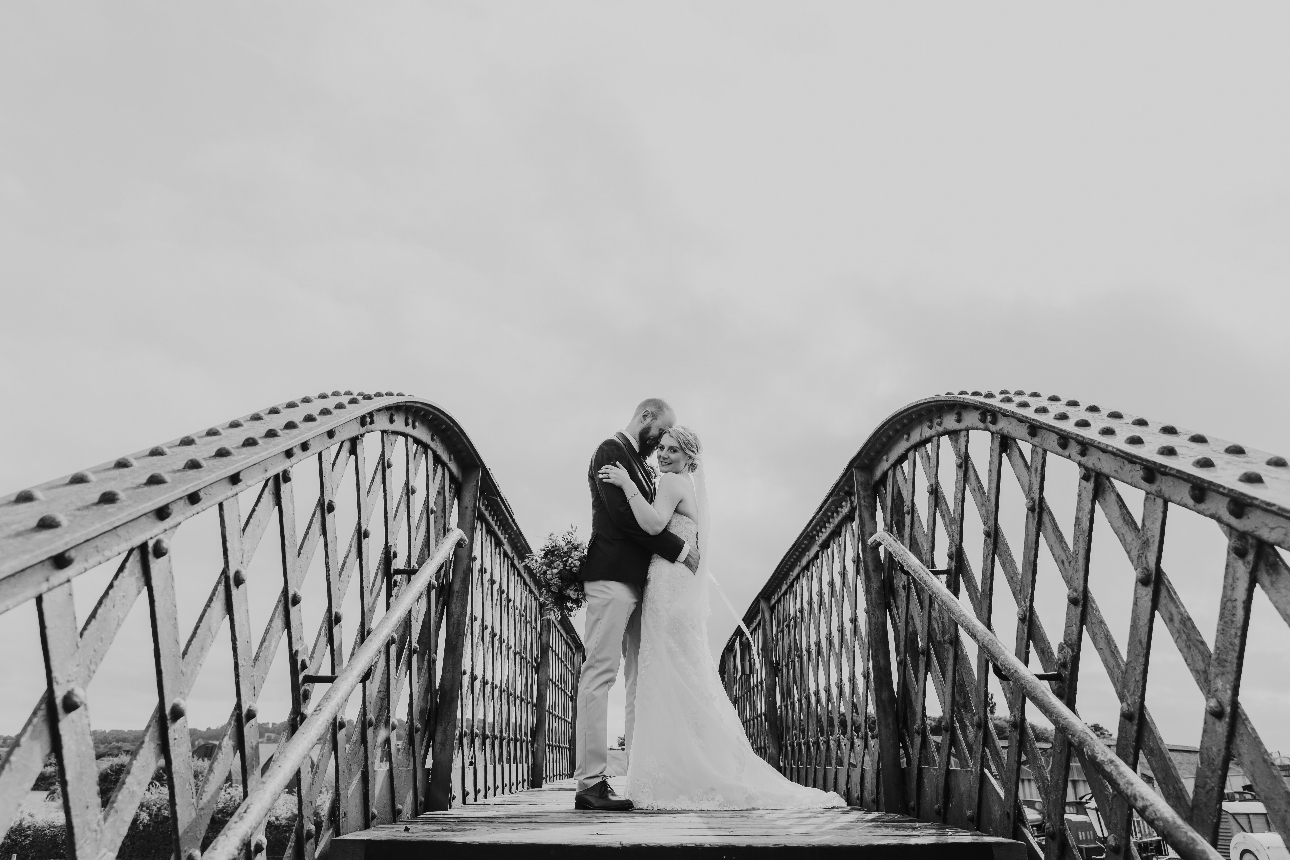 Couple pose on bridge