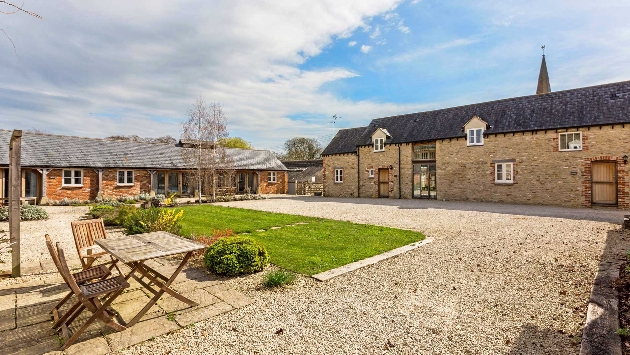 cottages around a courtyard with some grass