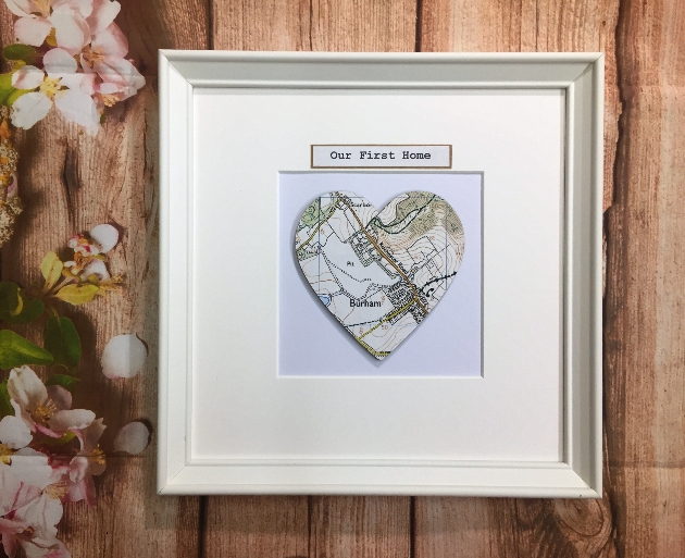 white frame with cut out white heart with a map of a road name