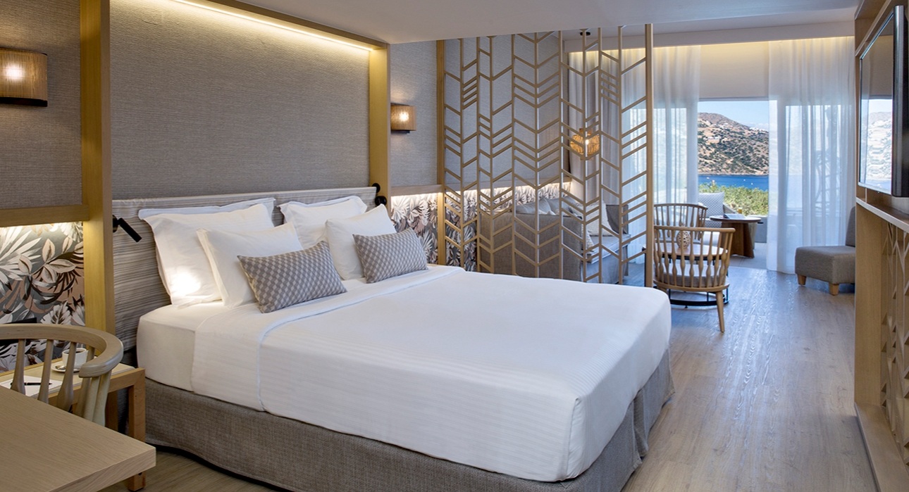 large bedroom, neutral decor sea views