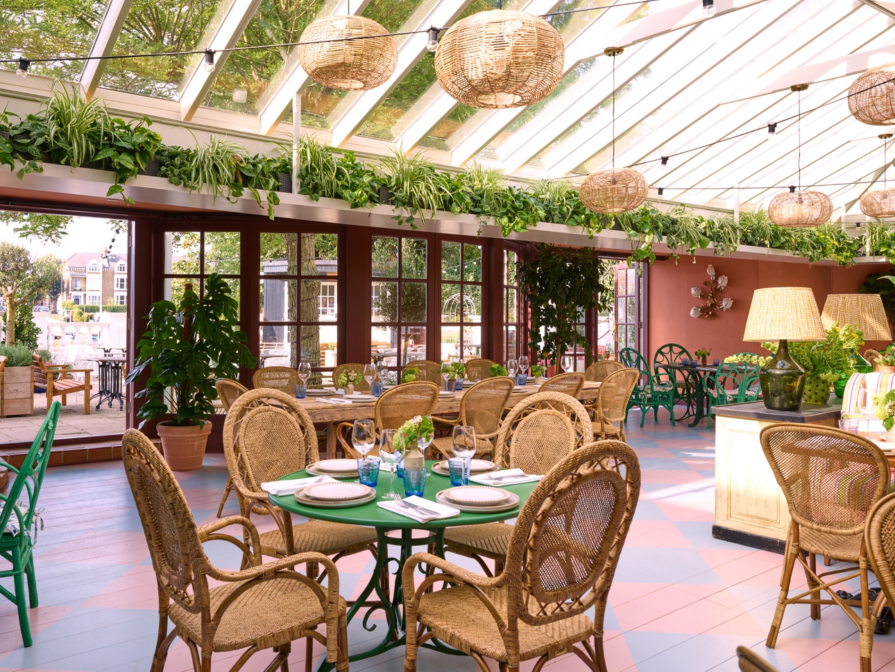 conservatory-style restaurant with wicker tables and chairs