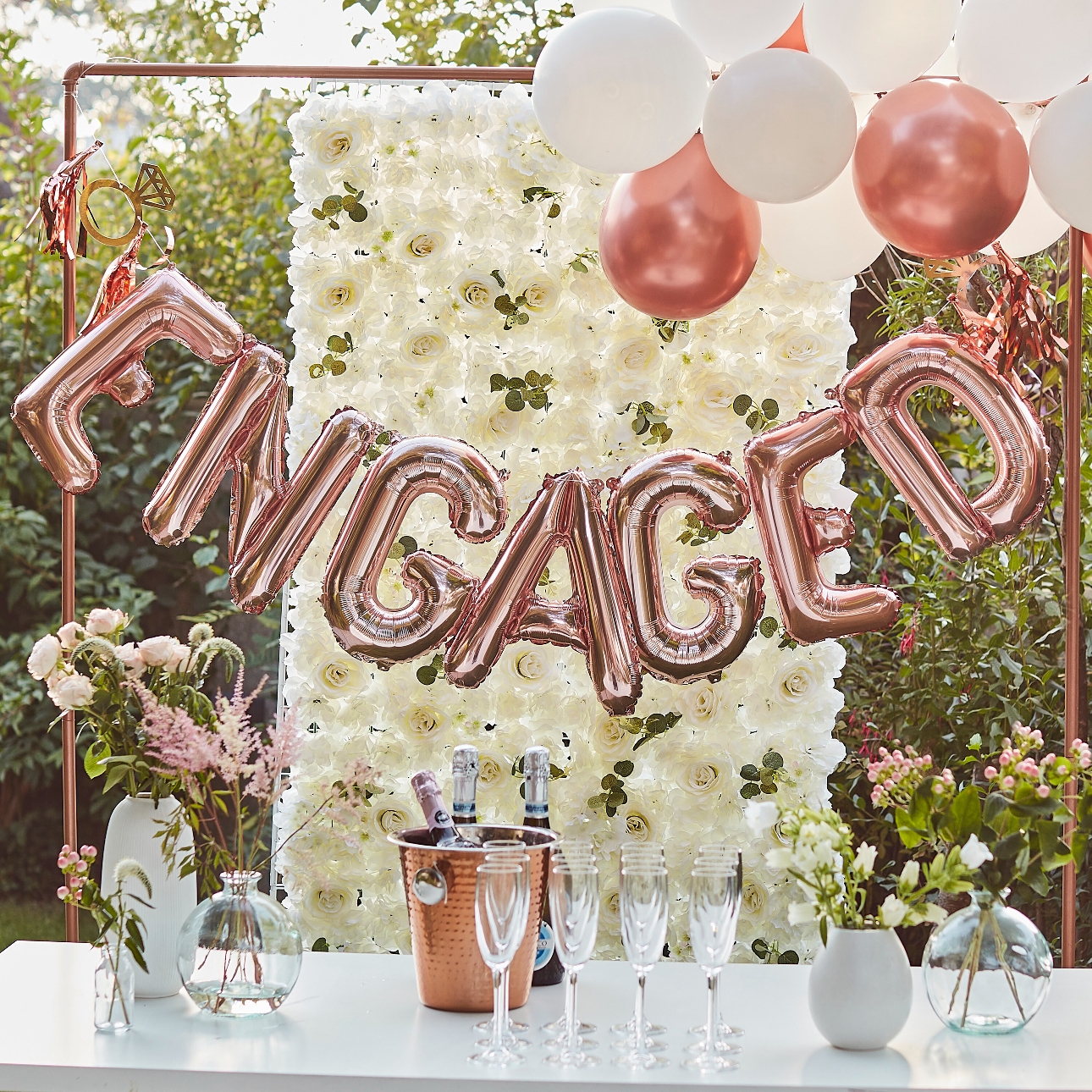 rose gold foil balloons in the word engagement 