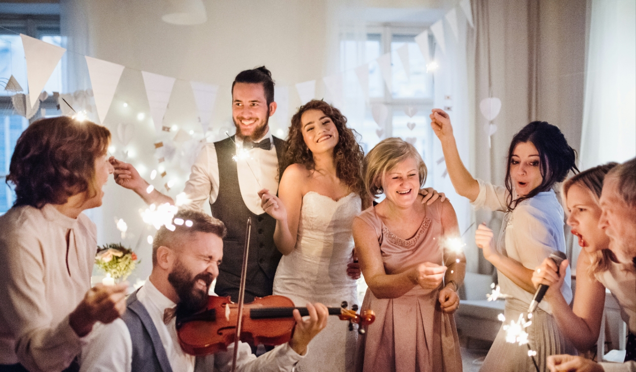 Bride and groom surrounded by family