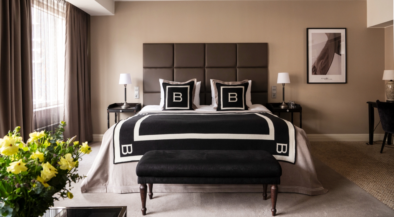 hotel rom with black and white accents and yellow flowers in bottom corner 