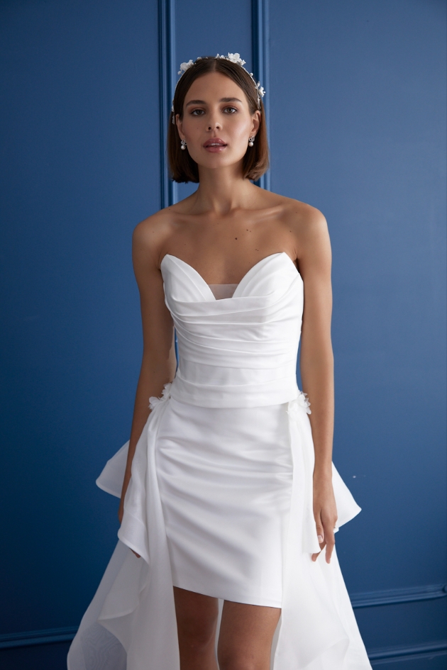 woman in short white dress with flower crown