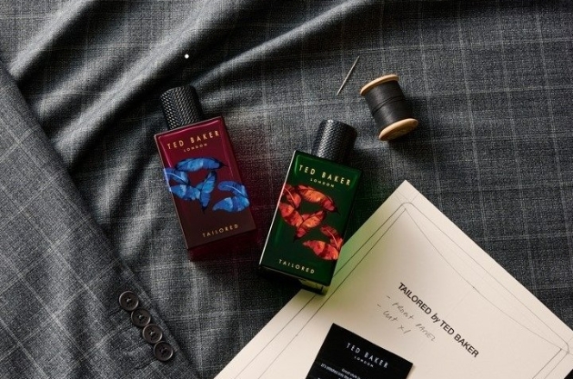 a red and green glass fragrance bottles laid on suit material