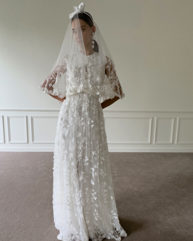 woman in very lacy wedding dress with the veil pulled over her face