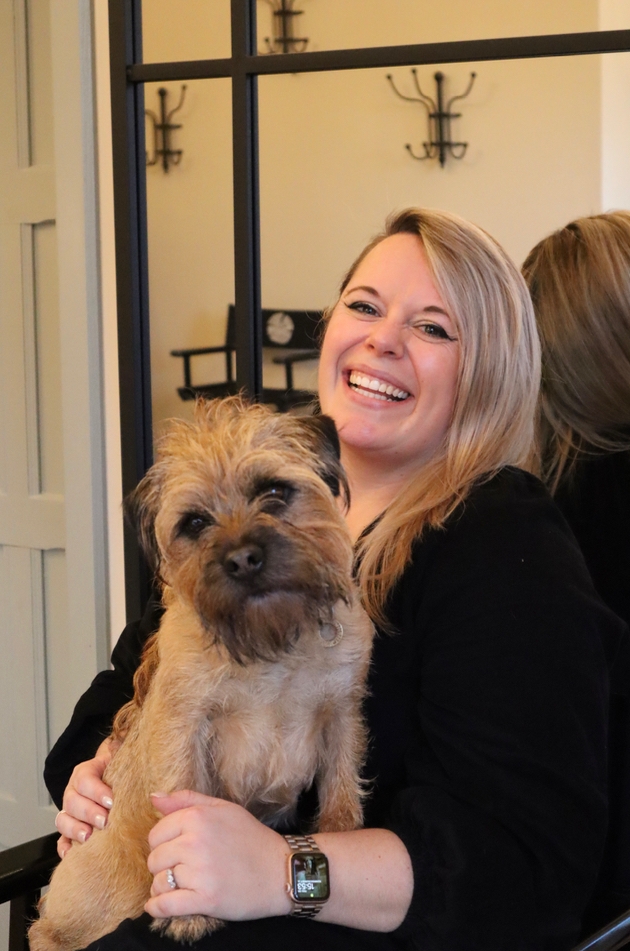 A dog with a member of the team at wedding venue the Post Barn