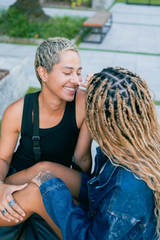 two women sat on the floor embracing 