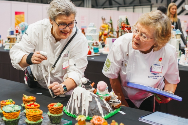 two ladies baking a cake