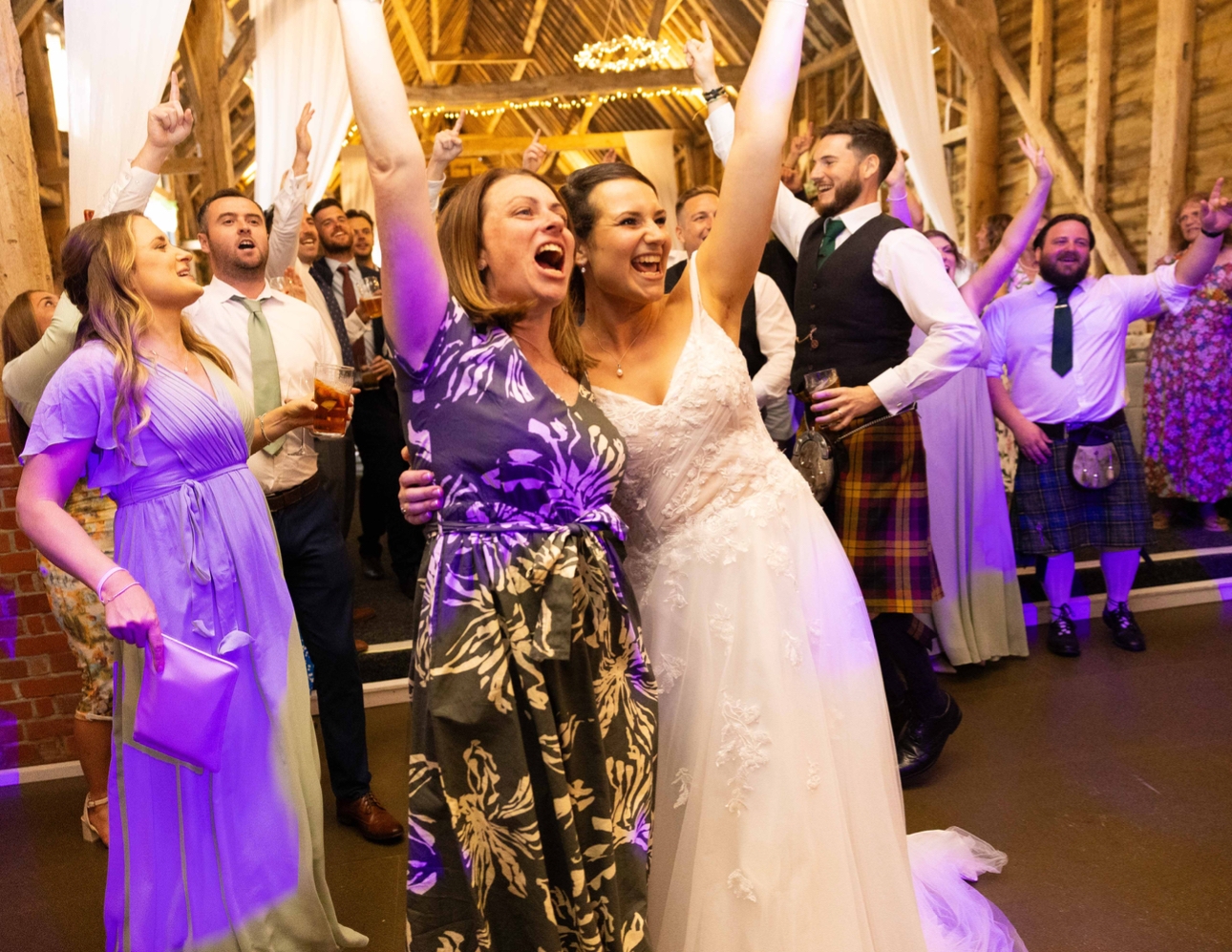 A bride and her guests dancing at a wedding reception