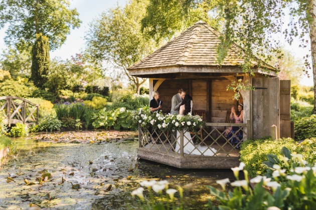 Outdoor wooden ceremony area over a lake 